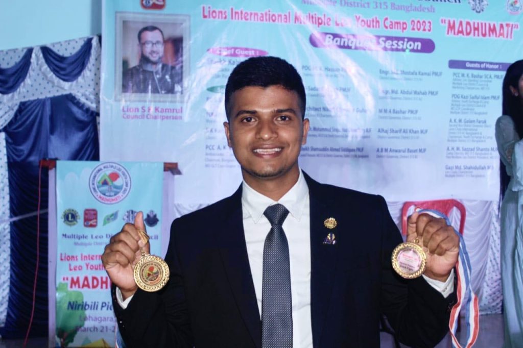 Jubayer Hossain holding two medals in his hand.